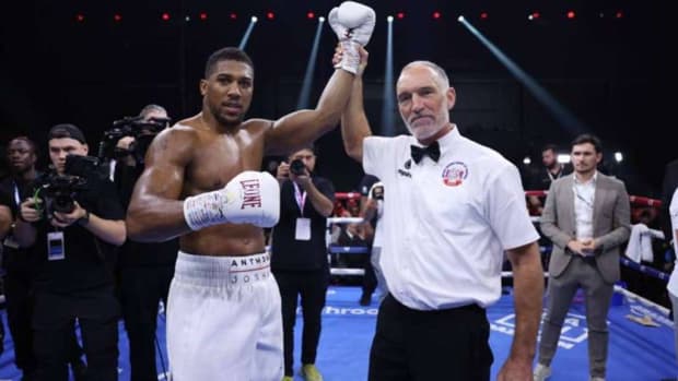Anthony Joshua celebrates victory as Referee Steve Gray announces him as winner following the Heavyweight fight between Anthony Joshua and Otto Wallin during the Day of Reckoning: Fight Night at Kingdom Arena. According to promoter Eddie Hearn, Anthony Joshua faces a high-stakes matchup against Francis Ngannous, who resembles Godzilla. RICHARD PELHAM/GETTY IMAGES. 